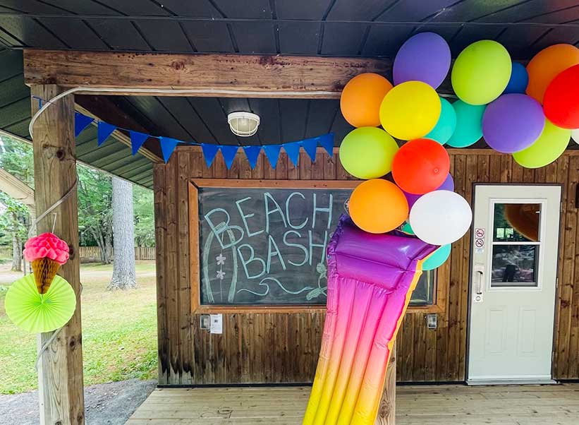 photo of beach bash chalk board and balloons